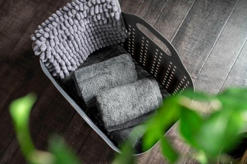 a black chair with pillows on a wooden floor at Silk Court 405 in Chitose