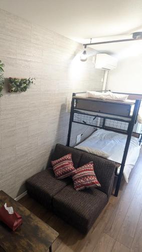 a couch in a room with a bunk bed at 15min from Haneda Airport Cozy for 3 in Tokyo
