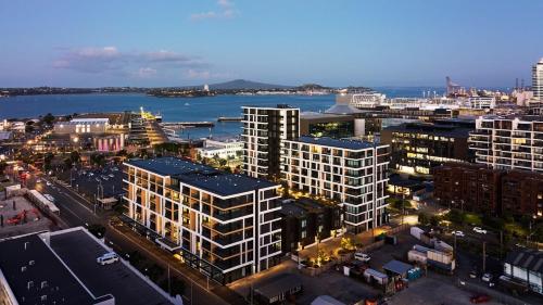 an aerial view of a city with buildings and the water at Beaumont Residence in Auckland