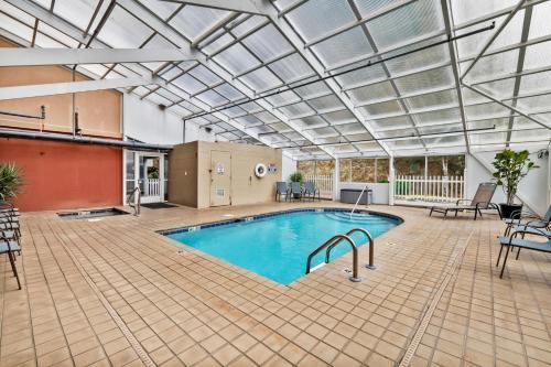 a large indoor pool with a glass ceiling at Trendy 2 BDR Condo with Pool & Hot Tub Near Downtown in Gatlinburg