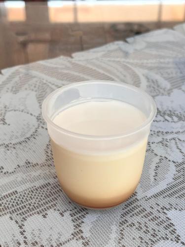 a plastic cup of milk sitting on a table at Coral B&B in Hengchun