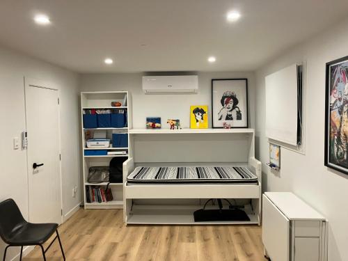 a white room with a desk and a chair at Seatoun Shores in Wellington