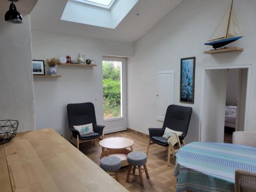 une chambre avec des chaises, une table et un lit dans l'établissement Maison proche plage, animaux admis, 8 pers à La Guérinière - FR-1-823-142, à La Guérinière