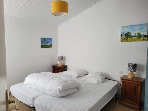a bedroom with two beds with white sheets at Maison à La Guérinière, proche plage, pour 6 personnes avec wifi - FR-1-823-25 in La Guérinière
