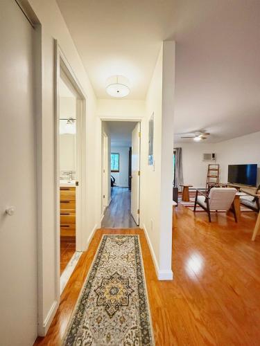 an empty living room with a rug on the floor at Peaceful Retreat on Chilton Lane in Brewster