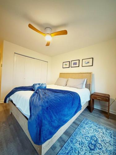 a bedroom with a large bed with a ceiling fan at Peaceful Retreat on Chilton Lane in Brewster