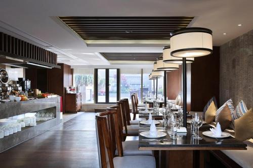 a dining room with a long table and chairs at SSAW Boutique Hotel Hangzhou Wildwind in Hangzhou