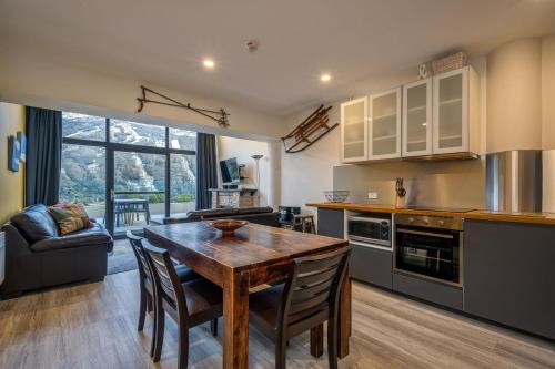 a kitchen with a table and chairs in a room at Lantern 34 - 2 Bedroom Terrace in Thredbo