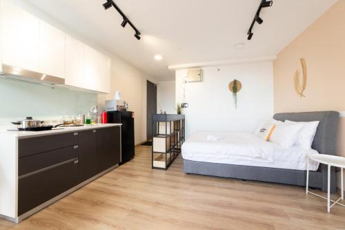 a kitchen and a bedroom with a bed in a room at Emporis Kota Damansara PJ by Sleepy Bear in Petaling Jaya
