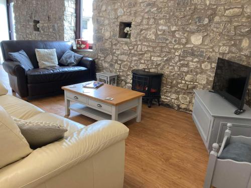 a living room with a couch and a fire place at Vale of Glamorgan - Cottage - Sleeps 4 - Parking in Barry