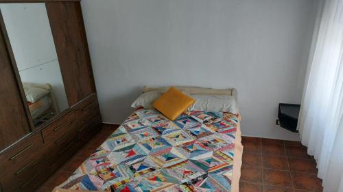 a bed with a pillow on it in a room at Casa a 800 mts de pleno centro in Villa Carlos Paz