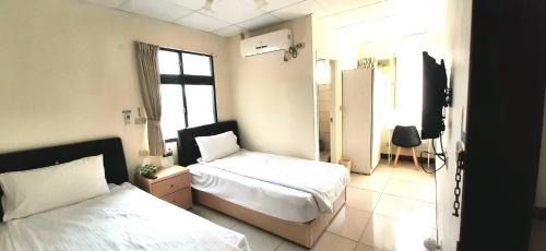 Postel nebo postele na pokoji v ubytování 大新民宿Da Xin Homestay