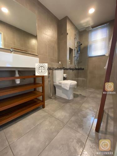a bathroom with a toilet and a shower and a sink at EMAS Suite Timurbay, Kuantan in Kuantan