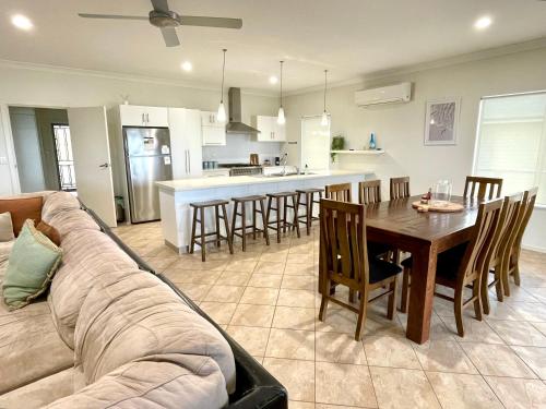 a living room and kitchen with a couch and a table at Africaine Voyage in Kingscote