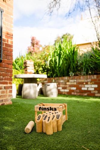 a wooden box sitting on the grass in a yard at The Residence of MacKenzie Quarters CBD Bendigo in Bendigo