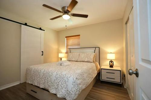 a bedroom with a bed and a ceiling fan at Villa On The Ocean in Fort Pierce