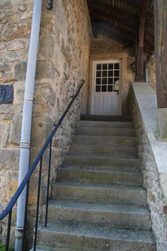 a set of stairs leading to a white door at Charming Gite In Mont Saint Vincent in Mont-Saint-Vincent