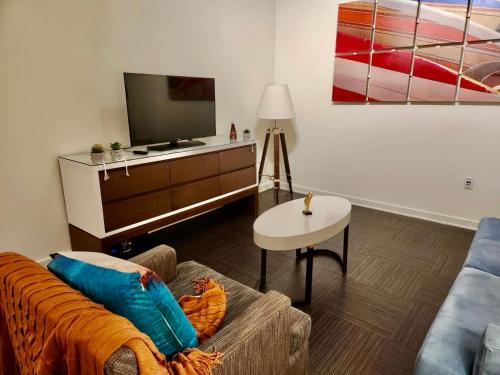 a living room with a couch and a tv at Modern Venice Beach Stay - Walk to Marina & Boardwalk in Los Angeles