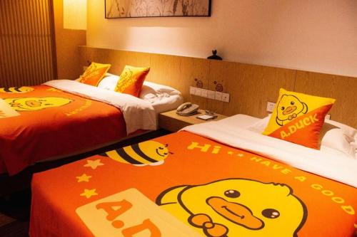 a hotel room with two beds with hello kitty signs on them at Xian Elegant Oriental Hotel in Xi'an
