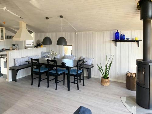 a kitchen and dining room with a table and chairs at Cozy Summer House With 100 Meters To The Sea in Haderslev