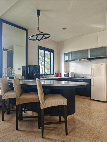 a kitchen with a large island in the middle at Sabah Beach Villas & Suites in Kota Kinabalu