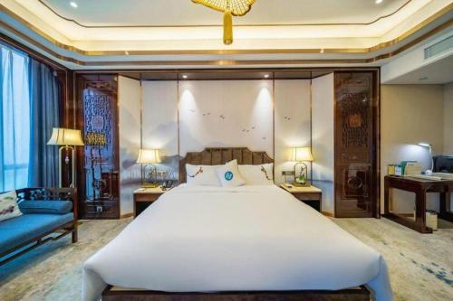 Katil atau katil-katil dalam bilik di Hou Yi Grand Hotel