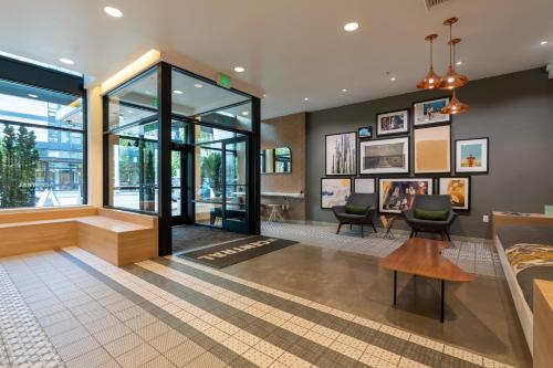 a lobby of a building with chairs and paintings at Central District Apartment- King Size Bed in Seattle