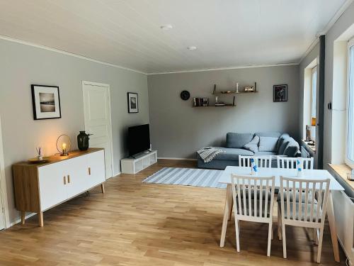 a living room with a couch and a table at Villa Kuninkaankivi in Kalajoki