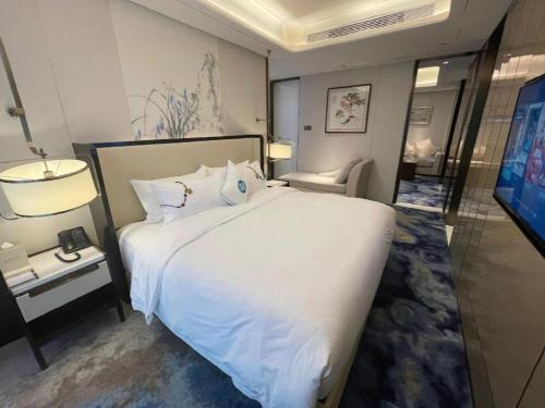 Katil atau katil-katil dalam bilik di Hou Yi Grand Hotel