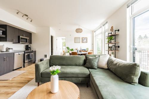 a living room with a green couch and a table at Central District Apartment- King Size Bed in Seattle