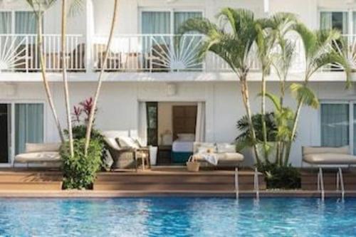 a hotel with a swimming pool in front of a building at EXCELLENCE PUNTA CANA - ALL INCLUSIVE - ADULTS ONLY in Punta Cana