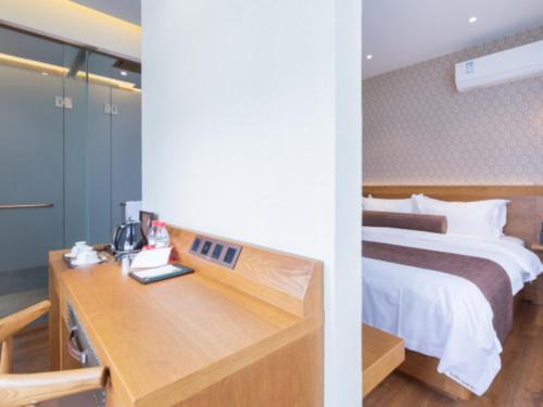 a hotel room with a bed and a desk at James Joyce Coffetel Qufu Tourist Center Gulou Street Sankong Scenic Spot in Jining
