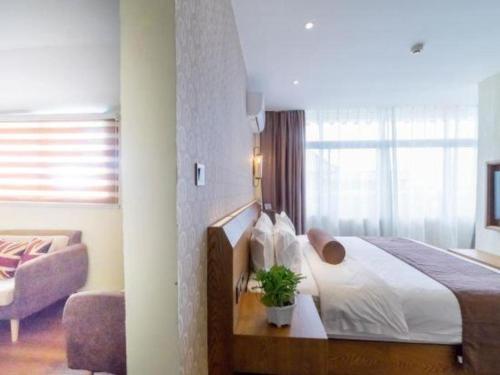 a bedroom with a bed with a plant on it at James Joyce Coffetel Qufu Tourist Center Gulou Street Sankong Scenic Spot in Jining