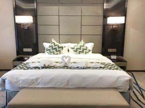 Postel nebo postele na pokoji v ubytování Enping Yucca Hotel