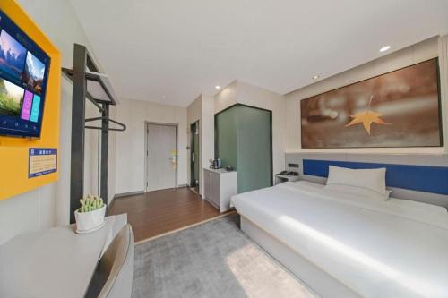 Ένα ή περισσότερα κρεβάτια σε δωμάτιο στο 7 Days Inn Tai'an Dongpingxi Hualian