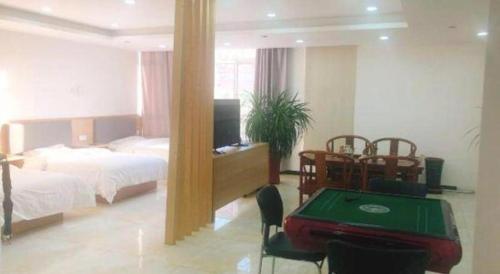 a hotel room with a bed and a table with a poker at 7Days Inn Tianjin Airport NO.1 Bridge Branch in Tianjin