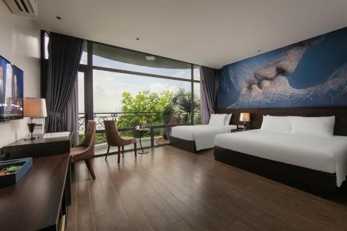 a hotel room with two beds and a large window at Westlake Pearl Suites & Spa 70 Xuan Dieu - By Pegasy Group in Hanoi
