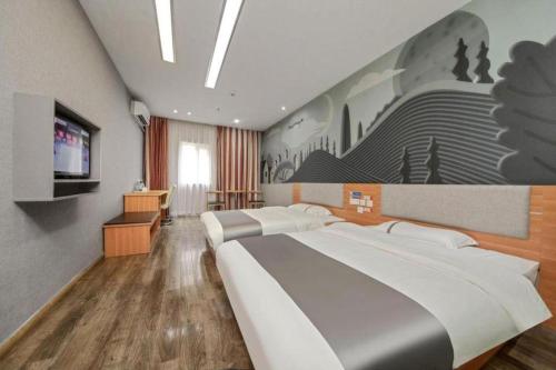 a bedroom with two beds and a flat screen tv at Thank Inn Plus Hotel Zhuhai Nanping pedestrian Street Huafa shopping Center in Zhuhai