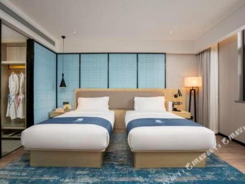 Ένα ή περισσότερα κρεβάτια σε δωμάτιο στο Echarm Hotel Jianshui Gucheng