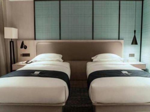 Ένα ή περισσότερα κρεβάτια σε δωμάτιο στο Echarm Hotel Jianshui Gucheng