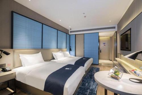 Letto o letti in una camera di Echarm Hotel Guilin Zhongshan Zhong Road Liangjiang Sihu
