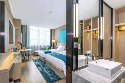 Letto o letti in una camera di Echarm Hotel Guilin Zhongshan Zhong Road Liangjiang Sihu