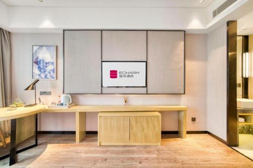 an office with a desk in a room at Echarm Hotel Jingjiang Bus Passenger Station Fanggu Street in Jingjiang