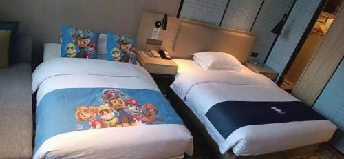 Katil atau katil-katil dalam bilik di Echarm Hotel Liuzhou High-speed Railway Station