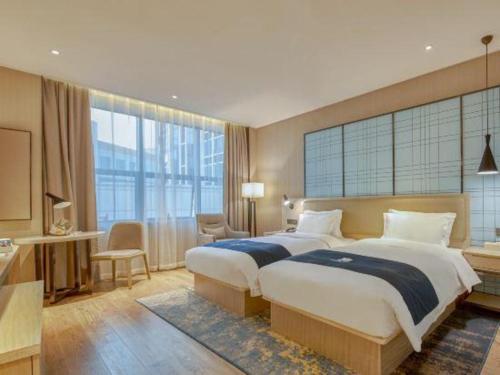 Katil atau katil-katil dalam bilik di Echarm Hotel Liuzhou High-speed Railway Station