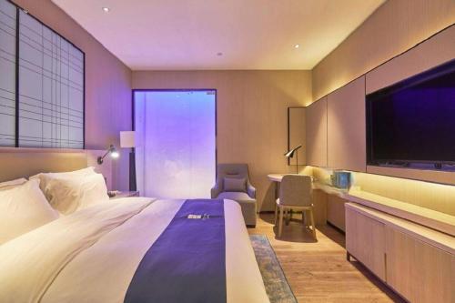 Katil atau katil-katil dalam bilik di Echarm Hotel Liuzhou High-speed Railway Station