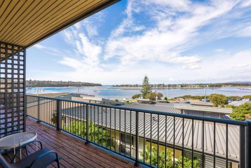 a balcony with a view of the water at Penguin Mews Merimbula in Merimbula