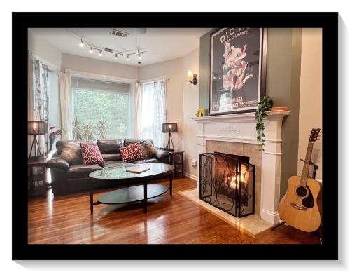 a living room with a couch and a fireplace at The Banksy-Free Parking -4 bedroom w King bed- Firepit Rooftop near United Center in Chicago