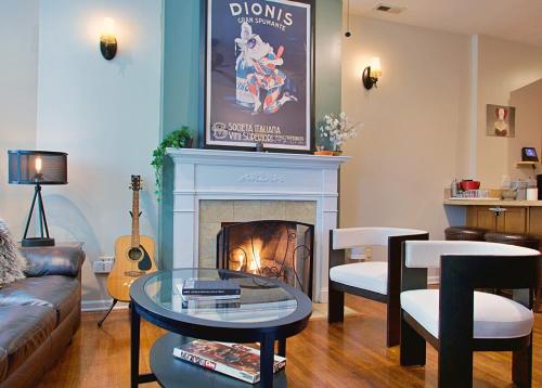 a living room with a couch and a fire place at The Banksy-Free Parking -4 bedroom w King bed- Firepit Rooftop near United Center in Chicago