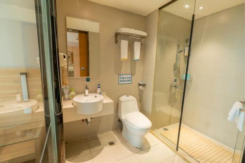 a bathroom with a toilet and a sink and a shower at City Comfort Inn Yingcheng Railway Station Shanghe Square in Xiaogan